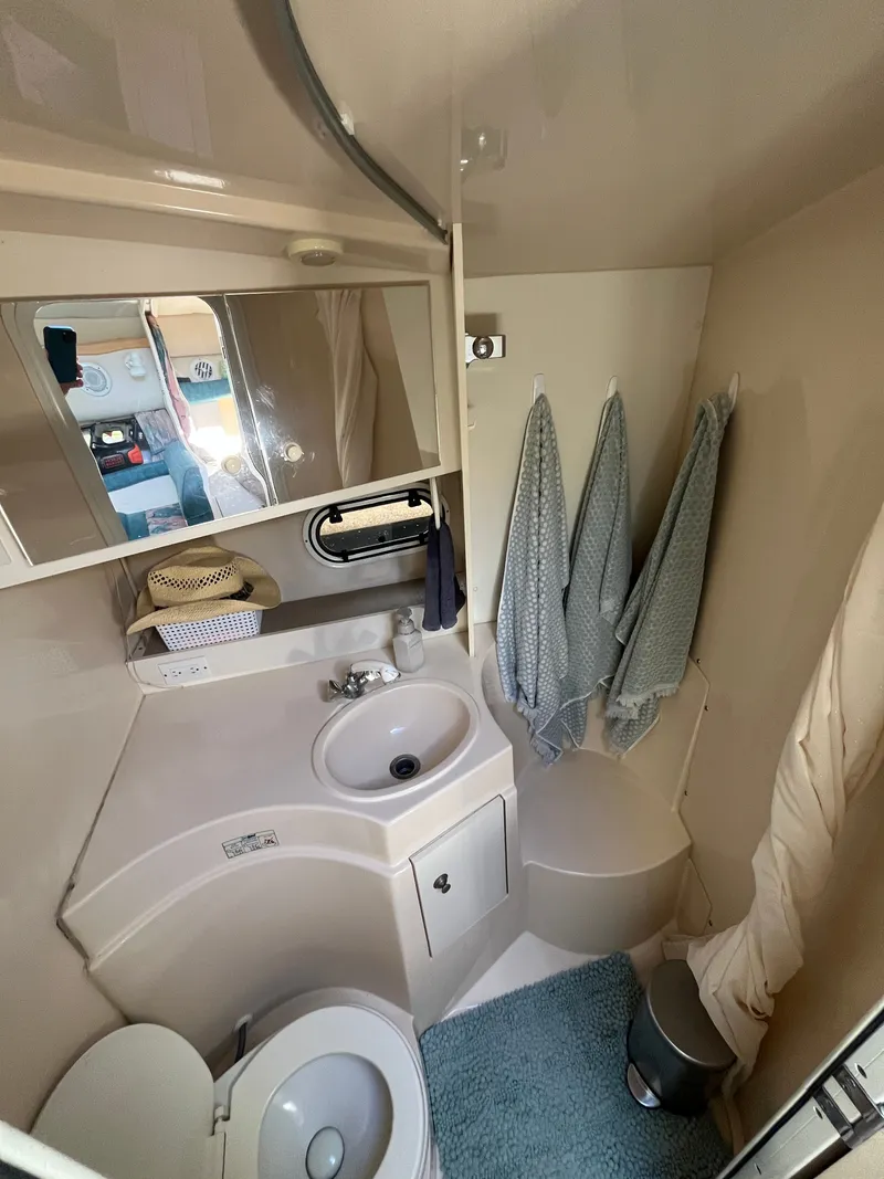 Slide: The Image of Bathroom interior of 1996 Cruisers Yachts 3375 with sink, toilet, and towels. - 9