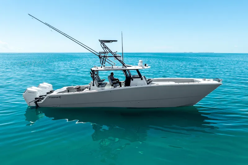 The Image of 2024 Freeman 42 boat on clear blue ocean water, side view. - 0