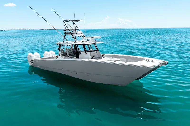 Slide: The Image of 2024 Freeman 42 boat on clear blue water, featuring multiple outboard engines. - 1