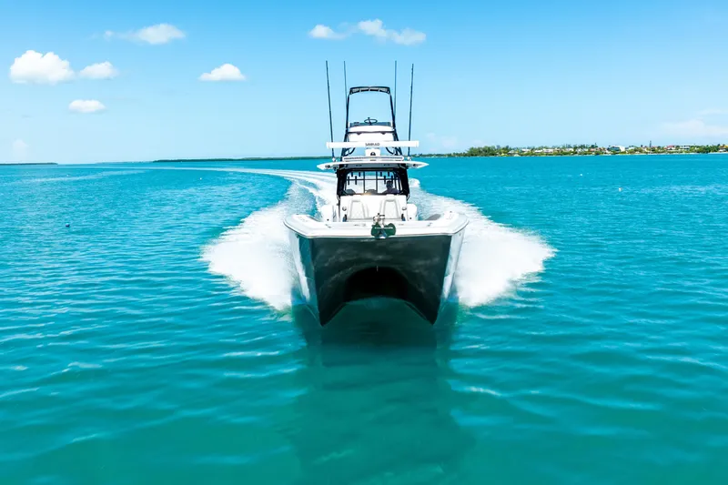 Slide: The Image of 2024 Freeman 42 boat cruising on clear blue water under a sunny sky. - 11