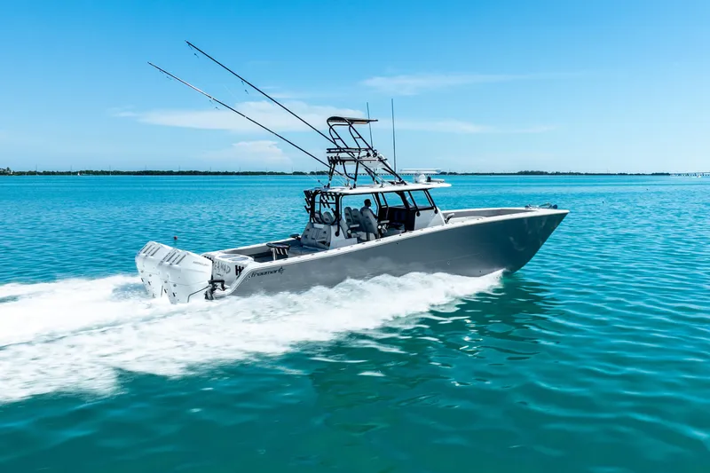Slide: The Image of 2024 Freeman 42 boat cruising on clear blue water under a sunny sky. - 13