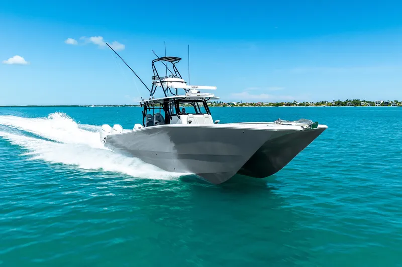 Slide: The Image of 2024 Freeman 42 boat cruising on clear blue water under a sunny sky. - 14