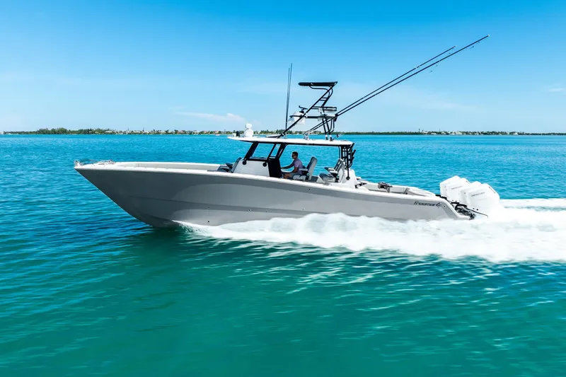 Slide: The Image of 2024 Freeman 42 boat cruising on clear blue water under a sunny sky. - 15