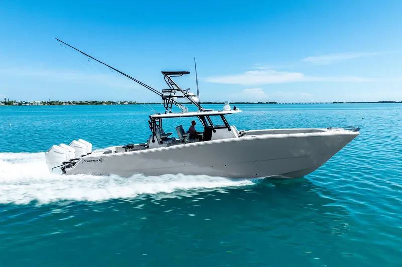 Slide: The Image of 2024 Freeman 42 boat cruising on clear blue water under a sunny sky. - 16