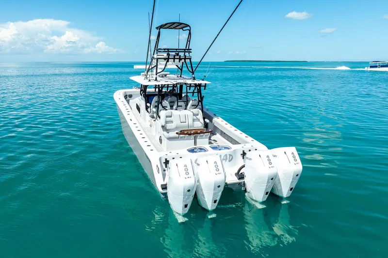 Slide: The Image of 2024 Freeman 42 boat with quad engines on clear blue water. - 20