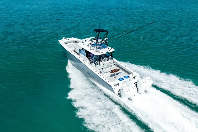 Slide: The Image of 2024 Freeman 42 boat cruising on clear blue water, showcasing powerful twin engines. - 21