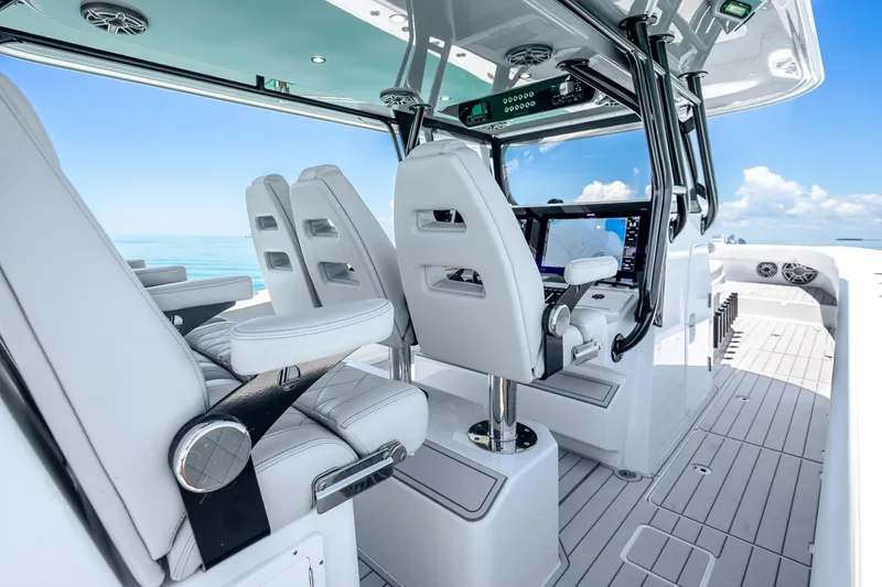 Slide: The Image of 2024 Freeman 42 boat interior with modern helm and seating, ocean view. - 25