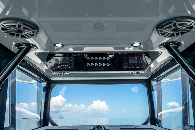 Slide: The Image of Interior view of 2024 Freeman 42 boat cockpit with navigation equipment and ocean backdrop. - 26