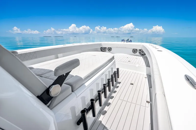 Slide: The Image of 2024 Freeman 42 boat interior with rod holders, sleek design, and ocean view. - 34