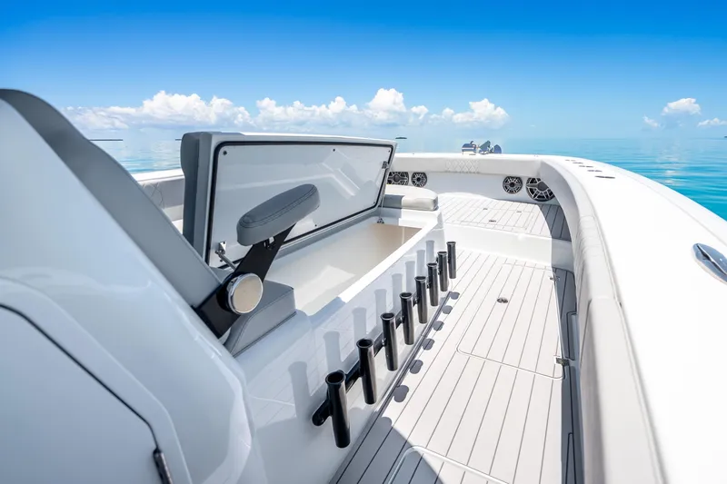 Slide: The Image of 2024 Freeman 42 boat interior with rod holders, open storage, and ocean view. - 36