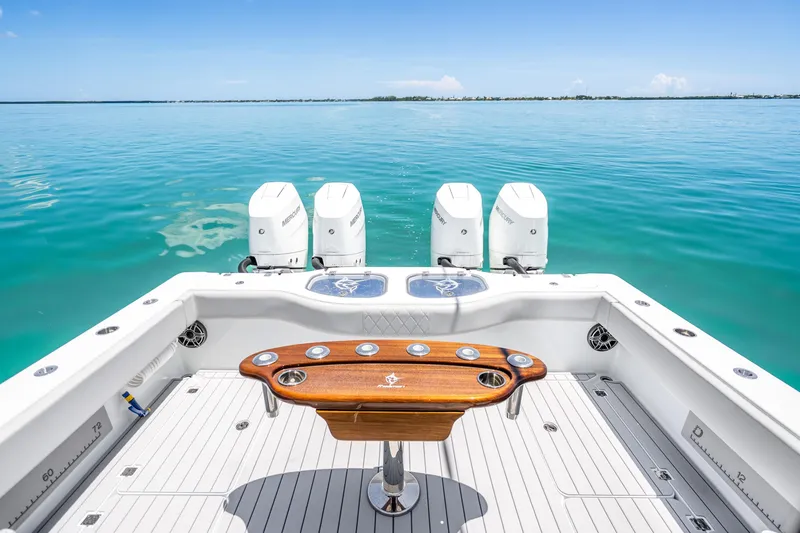 Slide: The Image of 2024 Freeman 42 boat with four engines, wooden table, and ocean view. - 39