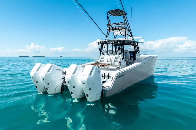 Slide: The Image of 2024 Freeman 42 boat with multiple engines on clear blue water. - 4