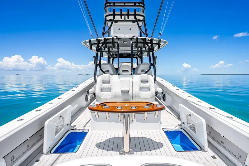 Slide: The Image of 2024 Freeman 42 boat interior with luxurious seating and fishing amenities on calm blue waters. - 42