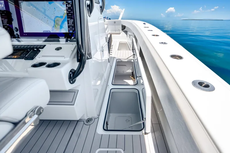 Slide: The Image of 2024 Freeman 42 boat interior with open storage compartments and navigation system. - 43