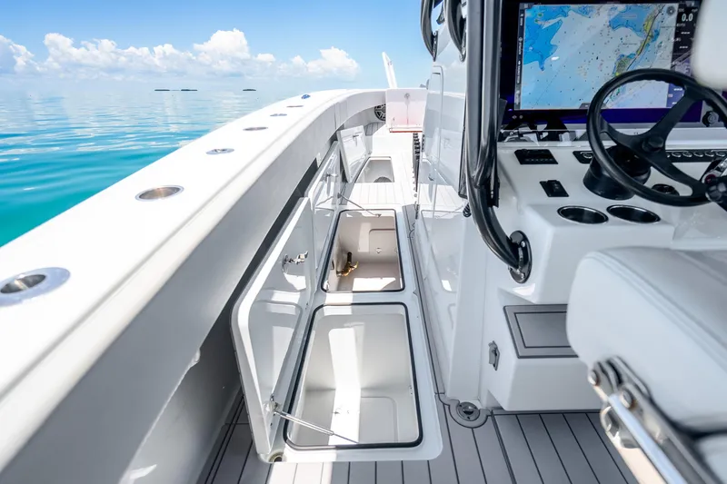 Slide: The Image of 2024 Freeman 42 boat interior with open storage compartments and navigation system. - 44