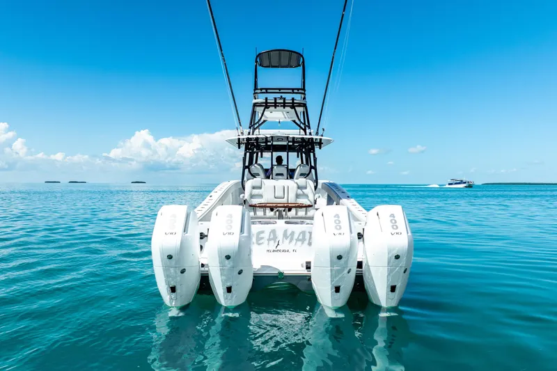 Slide: The Image of 2024 Freeman 42 boat with quad engines on clear blue water. - 5