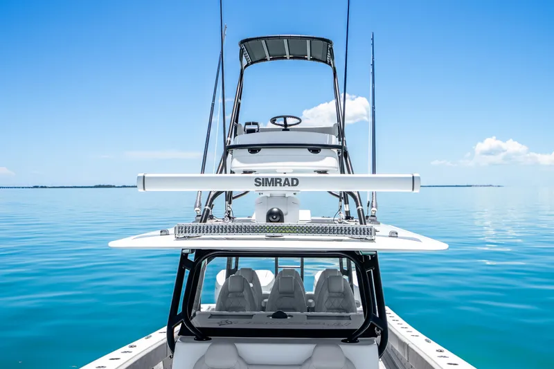 Slide: The Image of 2024 Freeman 42 boat on calm blue water, featuring Simrad equipment. - 50