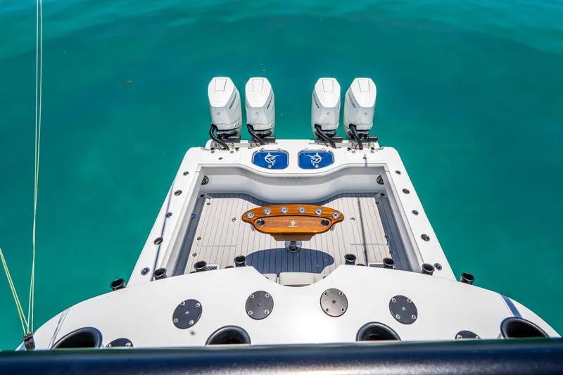 Slide: The Image of 2024 Freeman 42 boat with four engines on turquoise water. - 51