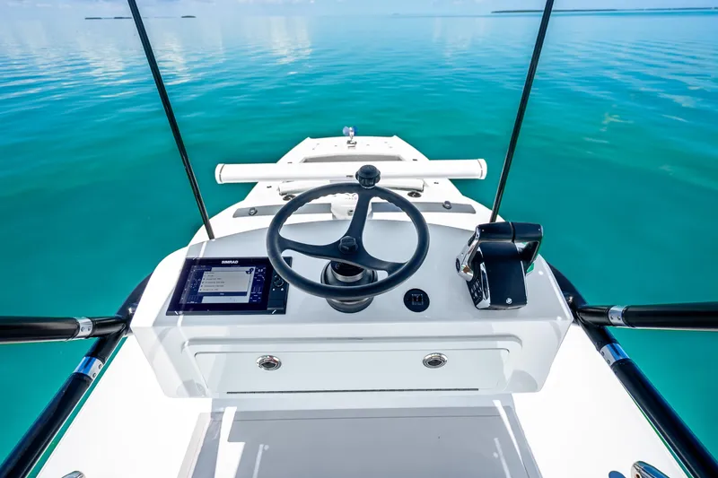 Slide: The Image of Steering console of 2024 Freeman 42 boat on clear blue water. - 52