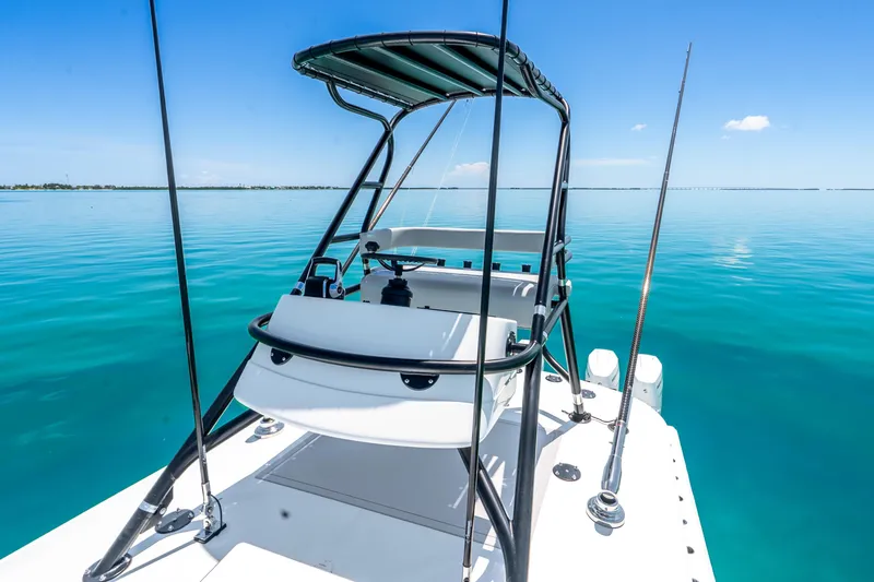 Slide: The Image of 2024 Freeman 42 boat on calm turquoise waters under clear blue sky. - 53