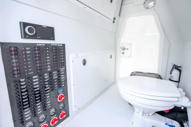 Slide: The Image of Interior of 2024 Freeman 42 boat with control panel and marine toilet. - 56