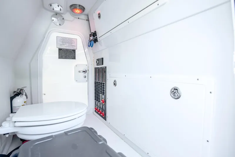 Slide: The Image of 2024 Freeman 42 boat interior with toilet, control panel, and fire extinguisher. - 58