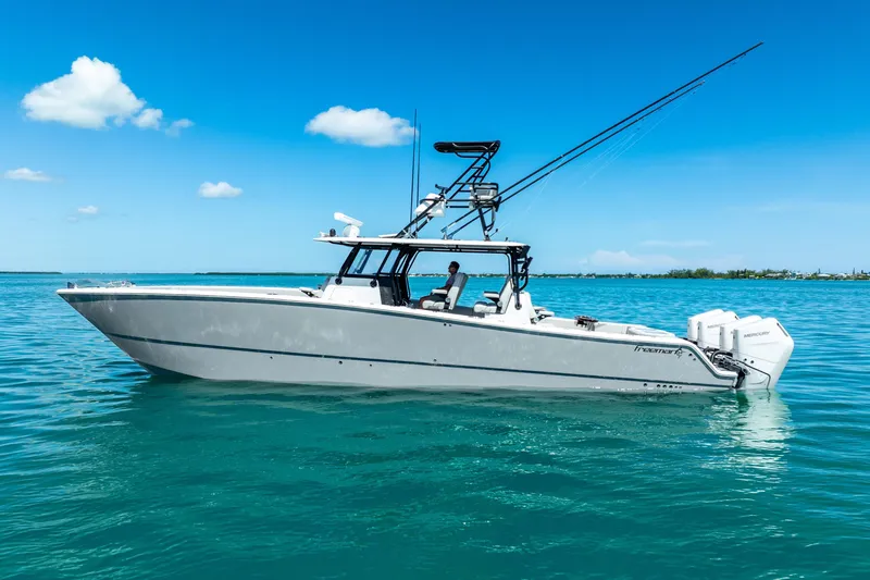 Slide: The Image of 2024 Freeman 42 boat on clear blue water under a sunny sky. - 6