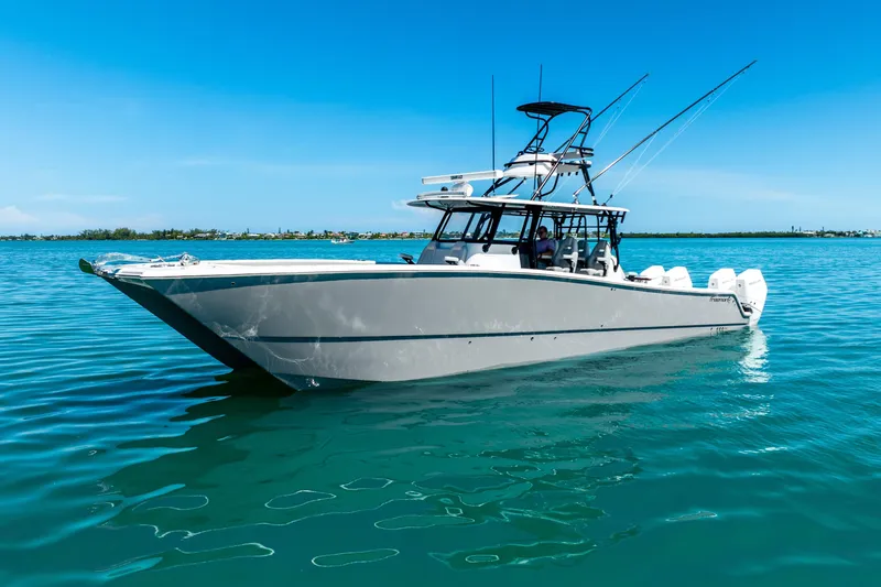 Slide: The Image of 2024 Freeman 42 boat on calm blue water under clear sky. - 7