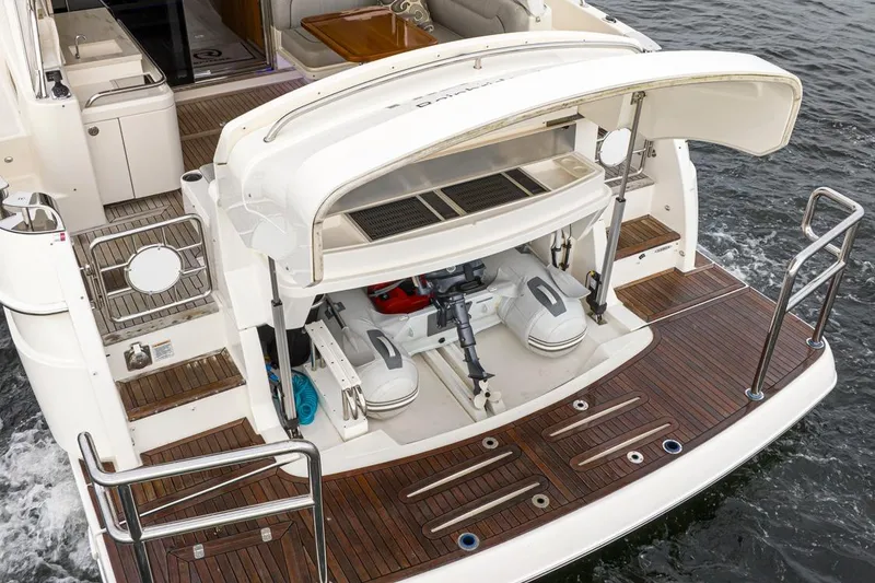 Slide: The Image of 2018 Riviera 4800 Sport Yacht with open engine compartment on teak deck. - 10