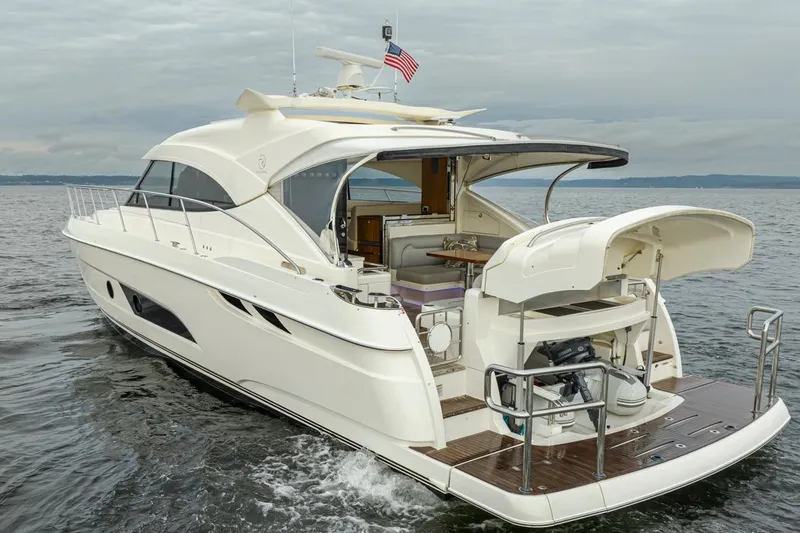 Slide: The Image of 2018 Riviera 4800 Sport Yacht cruising on open water, showcasing sleek design and luxury features. - 12