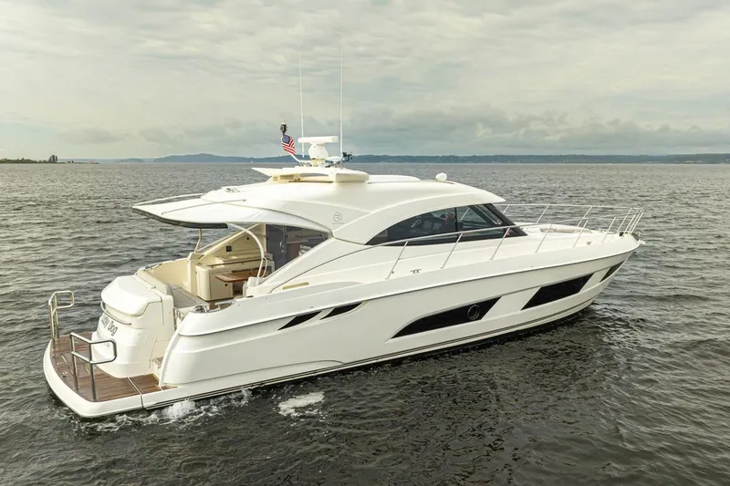 Slide: The Image of 2018 Riviera 4800 Sport Yacht cruising on open water. - 15