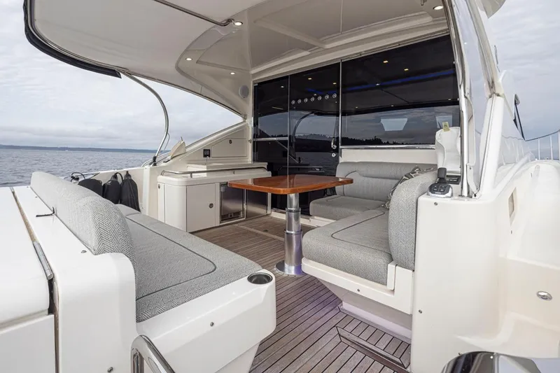 Slide: The Image of 2018 Riviera 4800 Sport Yacht interior with elegant seating and ocean view. - 21