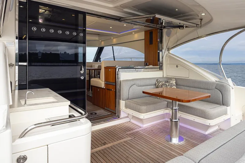 Slide: The Image of Luxurious 2018 Riviera 4800 Sport Yacht interior with elegant seating and ocean view. - 25