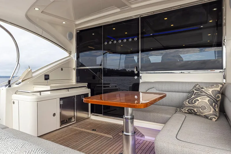 Slide: The Image of Luxurious interior of 2018 Riviera 4800 Sport Yacht with elegant seating and wooden table. - 26
