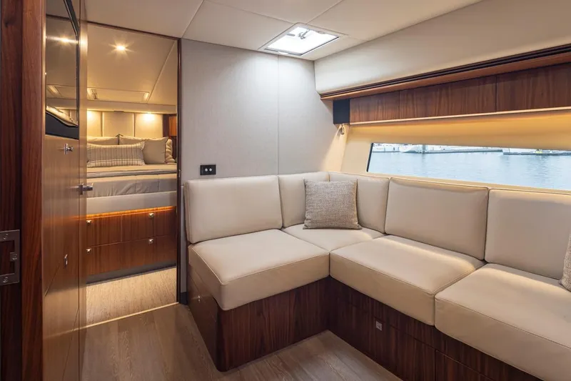 Slide: The Image of Luxurious interior of 2018 Riviera 4800 Sport Yacht with elegant seating and bedroom view. - 29