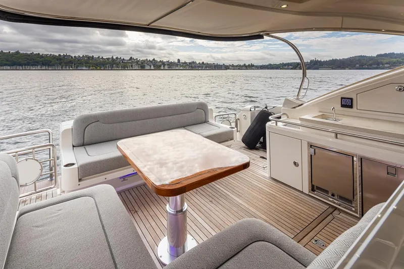 Slide: The Image of Luxurious 2018 Riviera 4800 Sport Yacht interior with elegant seating and scenic water view. - 30
