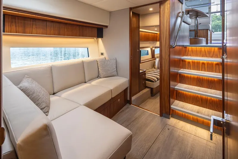 Slide: The Image of Luxurious interior of 2018 Riviera 4800 Sport Yacht with elegant wood finishes and cozy seating. - 35