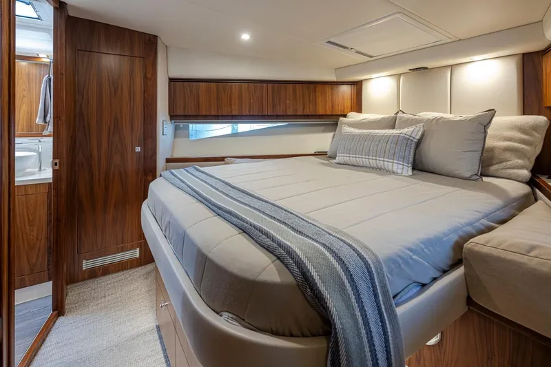 Slide: The Image of Luxurious bedroom interior of 2018 Riviera 4800 Sport Yacht with elegant wood finishes. - 36