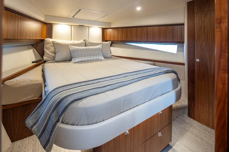 Slide: The Image of Luxurious bedroom interior of 2018 Riviera 4800 Sport Yacht with elegant wood finishes. - 37