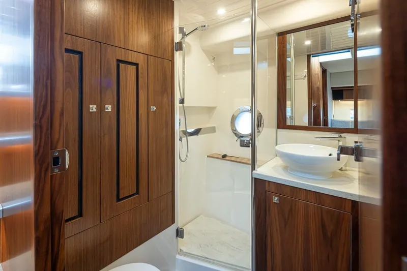 Slide: The Image of Luxurious bathroom in 2018 Riviera 4800 Sport Yacht with wood accents and modern fixtures. - 40