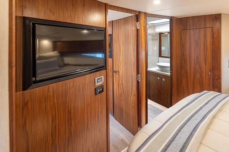 Slide: The Image of Interior of 2018 Riviera 4800 Sport Yacht with wood paneling and modern amenities. - 41
