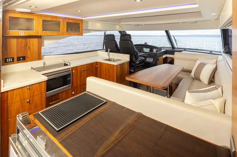 Slide: The Image of Luxurious interior of 2018 Riviera 4800 Sport Yacht with modern kitchen and seating area. - 42