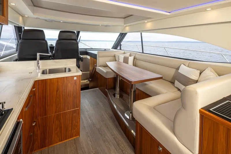 Slide: The Image of Luxurious interior of 2018 Riviera 4800 Sport Yacht with elegant seating and modern kitchen. - 44