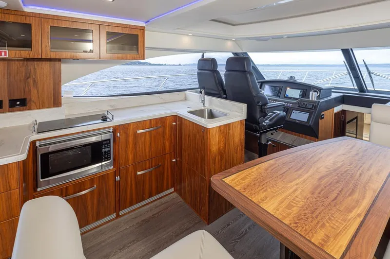 Slide: The Image of Luxurious interior of 2018 Riviera 4800 Sport Yacht with modern kitchen and helm. - 46