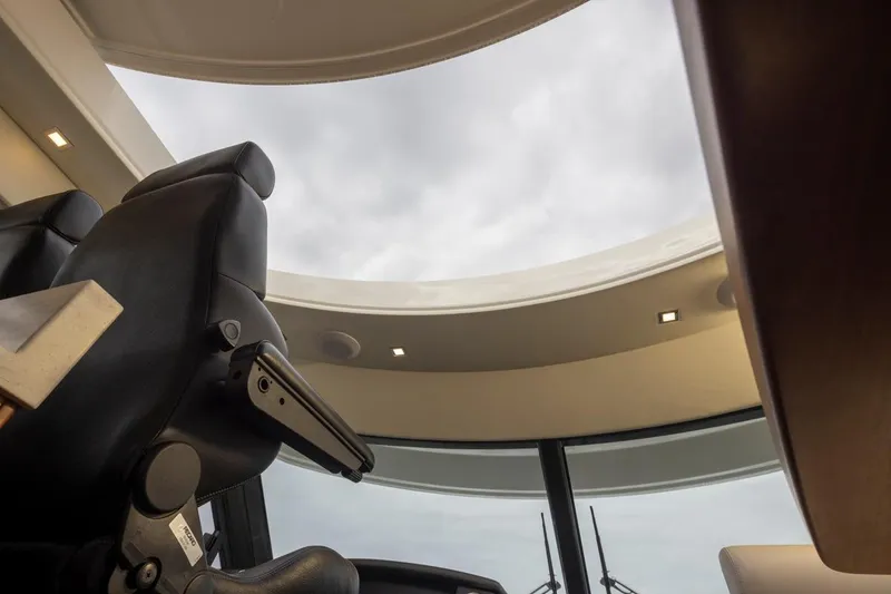 Slide: The Image of Interior view of 2018 Riviera 4800 Sport Yacht with skylight and leather seating. - 53