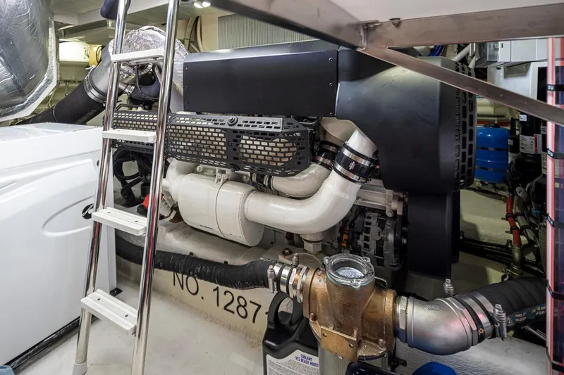 Slide: The Image of Engine room of 2018 Riviera 4800 Sport Yacht with visible machinery and ladder. - 57