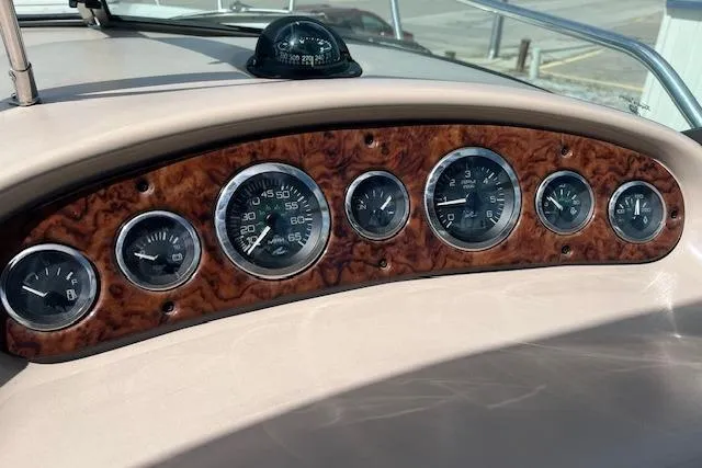 Slide: The Image of Dashboard of 2003 Sea Ray 260 Sundancer with wood finish and analog gauges. - 16