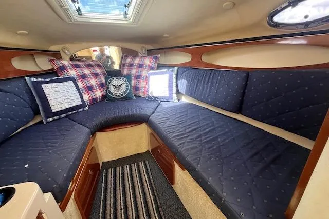 Slide: The Image of Interior of 2003 Sea Ray 260 Sundancer with blue seating and decorative pillows. - 27
