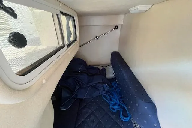 Slide: The Image of 2003 Sea Ray 260 Sundancer cabin interior with window and blue upholstery. - 41