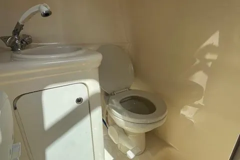 Slide: The Image of 2003 Sea Ray 260 Sundancer bathroom with sink and toilet. - 42